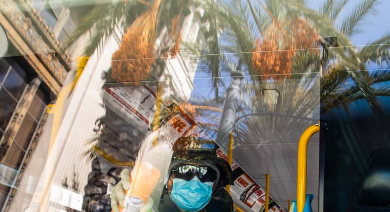 Long Beach Transit Worker, Mateo Alvorado, disinfects a bus in Long Beach, California on April 2, 2020. APU GOMES:AFP via Getty Images)