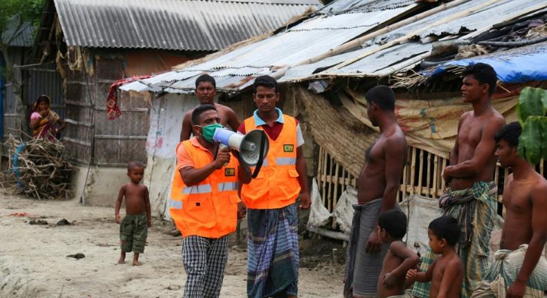 A volunteer urges residents to evacuate to shelters on May 19 ahead of the expected landfall of Super Cyclone Amphan in Khulna, Bangladesh