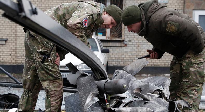 Police officers inspect the remains of a missile that fell in the street in Kyiv, Ukraine, on February 24, 2022.