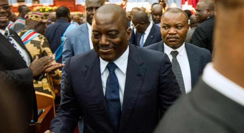 Congolese President Joseph Kabila (C) shakes hands during a special joint session of parliament on November 15, 2016 in Kinshasa