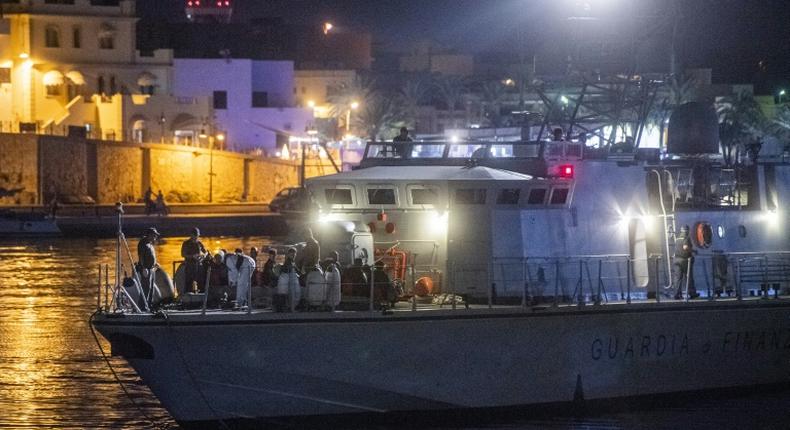 Italian authorities identified and carried out medical checks on the African migrants after they disembarked overnight on southern island Lampedusa after more than six days at sea