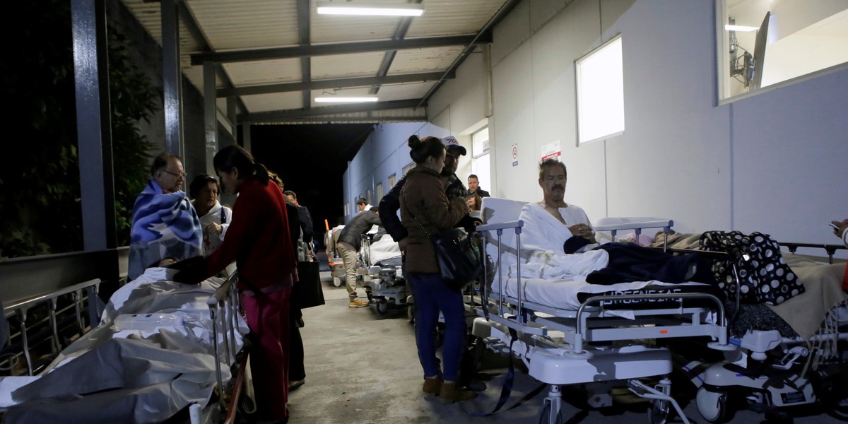 Evacuated patients wait outside a specialist hospital in Puebla, central Mexico, after the quake hit.