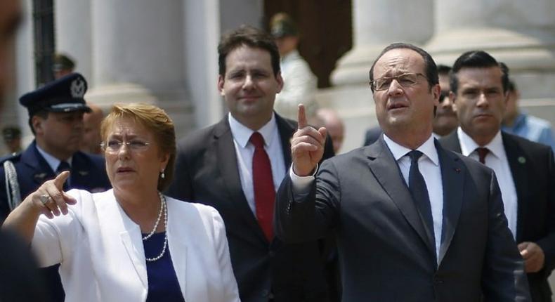 French President Francois Hollande (R) and his Chilean counterpart Michelle Bachelet leave a joint press conference at La Moneda Palace at the start of his two-day visit to Chile, in Santiago on January 21, 2017