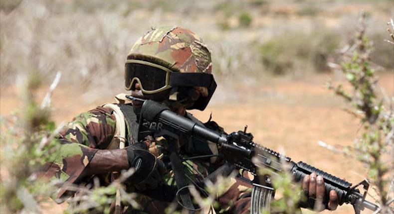 A Kenya Defence Forces (KDF) soldier, part of the African Mission in Somalia (AMISOM), secures an area during a foot patrol on the outskirts of the controlled area of the old airport in the coastal town of Kismayu in southern Somalia November 12, 2013. /REUTERS