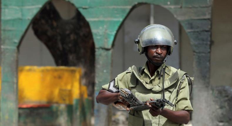 A riot policeman points his rifle towards protesters during a riot in Zanzibar October 19, 2012. REUTERS/Goran Tomasevic