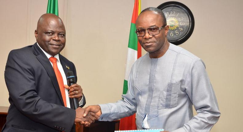 Dr. Emmanuel Ibe Kachikwu (R), the new managing director of the Nigerian National Petroleum Corp (NNPC), shakes hands with the former Group Managing Director of NNPC, Dr. Joseph Thlama Dawha during a handover ceremony in Abuja, Nigeria, in this August 5, 2015 handout photograph made available to Reuters August 6, 2015. REUTERS/NNPC/Handout