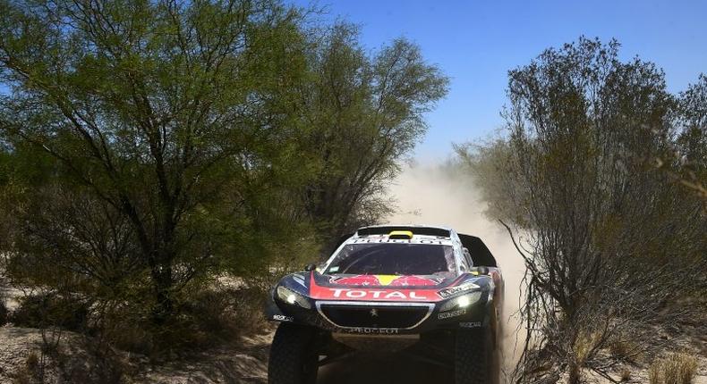 Peugeot's French driver Stephane Peterhansel and co-driver Jean Paul Cottret compete during the Stage 11 of the Rally Dakar 2016 between La Rioja and San Juan, Argentina, on January 14, 2016