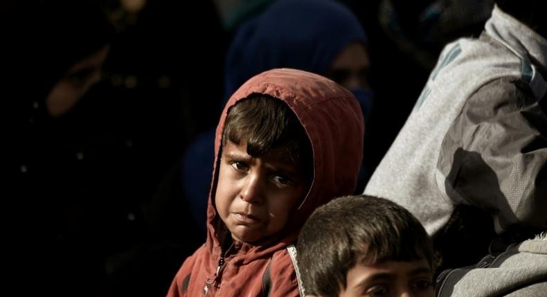 A displaced Iraqi boy cries as he flees Mosul on February 28, 2017