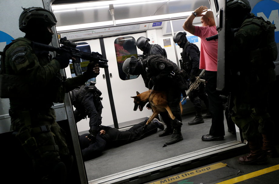 Brazilian military policemen of special-operations unit (BOPE) take part in an instructional exercise with officers of an elite unit of the French police, who are responsible for antiterrorist actions in France, ahead of the 2016 Rio Olympics at Rio de Janeiro's subway, June 10, 2016.
