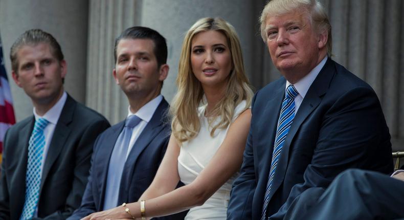 Donald Trump, right, sits with his children, from left, Eric Trump, Donald Trump Jr., and Ivanka Trump during a groundbreaking ceremony for the Trump International Hotel on July 23, 2014, in Washington.Evan Vucci/AP