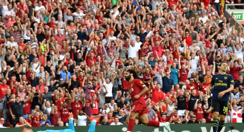 Streaking clear: Mohamed Salah (centre) scored twice in Liverpool's win over Arsenal