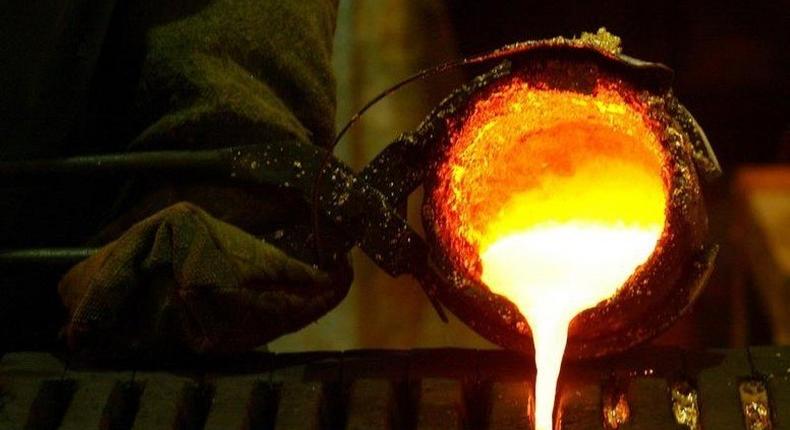 Refined gold is poured into moulds to be made into gold bars at South Africa's Rand Refinery in Germiston in a file photo. REUTERS/Siphiwe Sibeko