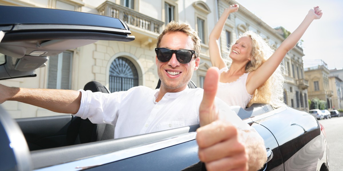 Car driver happy giving thumbs up - driving couple