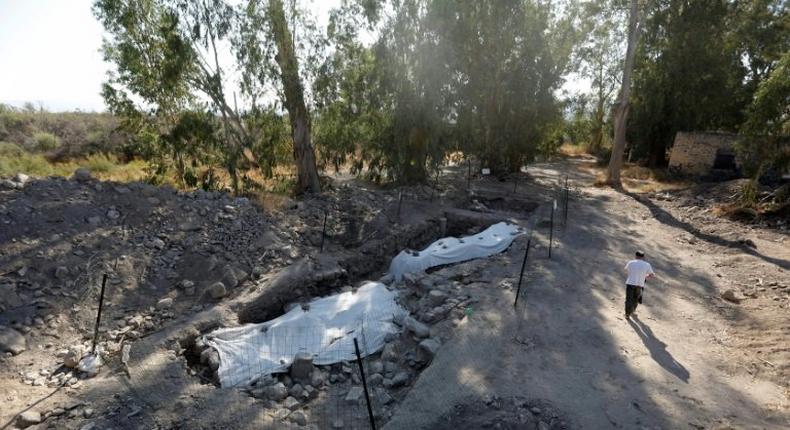 A man walks next to an archaeological site in northern Israel on August 6, 2017. The site is believed to be the location of a biblical village that was home to Saint Peter