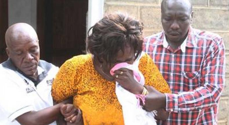 Family members overcome by grief during the burial of Collins Kipyegon Kalya
