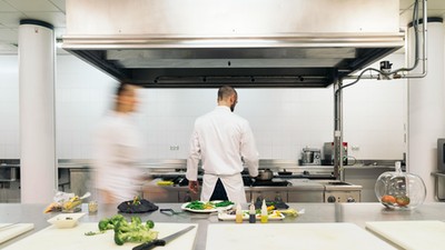 Two professionals chefs cooking together.