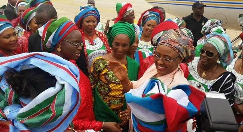 Wife of the President, Aisha Buhari (middle), wife of the Vice President, Dolapo Osinbajo (left) surrounded by women in Gombe state as the First Lady donated funds to bomb blast victims in the state.