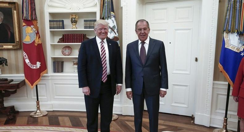 US President Donald J. Trump (left) poses with Russian Foreign Minister Sergei Lavrov during a meeting at the White House in Washington, DC on May 10, 2017