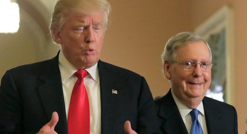 US President-elect Donald Trump gives a thumbs up sign as he walks with Senate Majority Leader Mitch McConnell on Capitol Hill in Washington, U.S.
