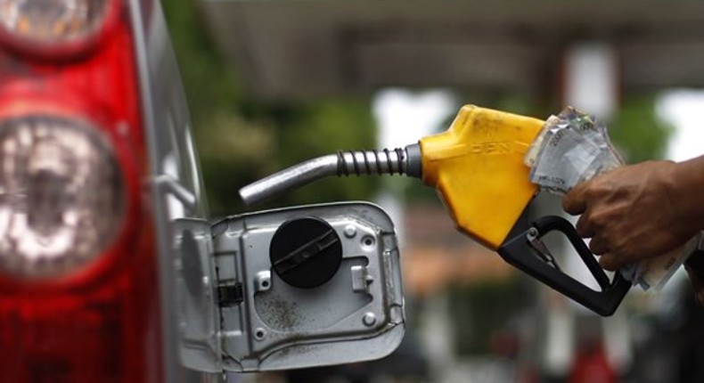 An attendant fueling a car