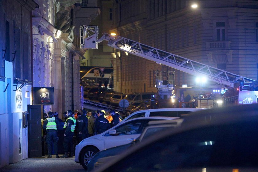 Firefighters work at the scene of a fire at a hotel in Prague