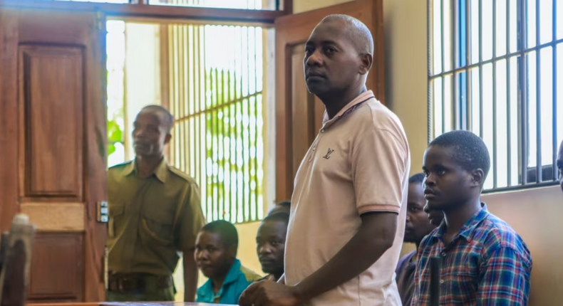 Pastor Paul Mackenzie Nthenge  accompanied by some of his followers during a court appearance in Malindi on April 17, 2023 [Photo: AP]