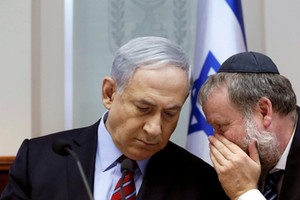 FILE PHOTO: Israel's Prime Minister Netanyahu listens to Cabinet Secretary in Jerusalem