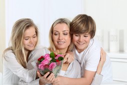 Children offering bunch of flowers on mother's 