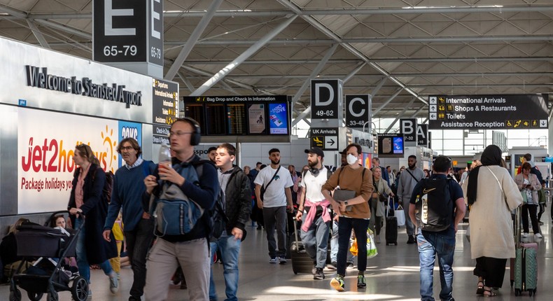 Travelers at Stansted Airport.