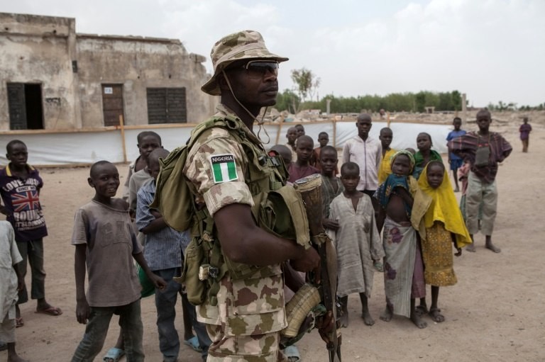 A Nigerian soldier patrols in the town of Banki in northeastern Nigeria on April 26, 2017. Banki has been totally destroyed during battles between the Nigerian army and Boko Haram insurgents. Over 32,000 people live in the town but free movement is limited.