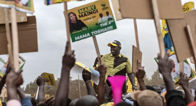 Kenya Kwanza political party coalition flag bearer, William Ruto arrives to the jubilation of placard carrying supporters during a campaign rally in Mwea constituency, Kirinyaga county in Kenya's central highlands on July 27, 2022. (Photo by TONY KARUMBA/AFP via Getty Images)