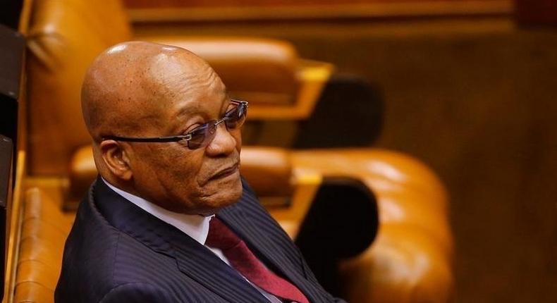 President Jacob Zuma looks on as members of Julius Malema's Economic Freedom Fighters (EFF) party raise objections before being evicted from Parliament during his question and answer session in Cape Town, South Africa, May 17, 2016. 