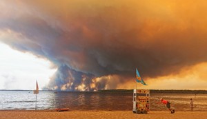 Posetioci plaže odmaraju se na plaži Mučik na obali jezera Lakano u Lakanou, na jugozapadu Francuske, dok požar besni u Žirondi, 24. jul 2026.