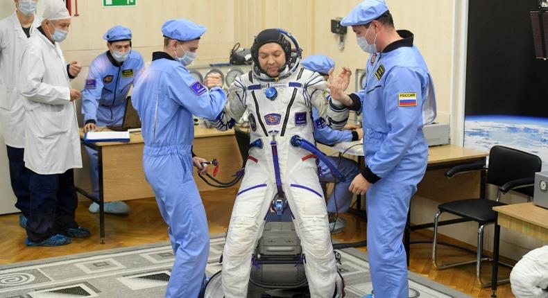 Oleg Kononenko, shown here being prepped for the December 3 launch, is a veteran cosmonaut on his fourth mission. He is set to reach 737 days by the time he returns to Earth on Tuesday  