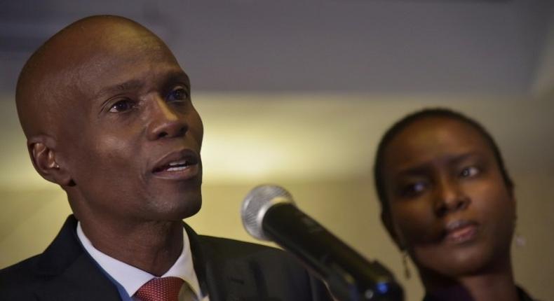 Jovenel Moise (L), presidential candidate of the PHTK party, speaks after preliminary results showed he had won the first round of Haiti's election on November 28, 2016