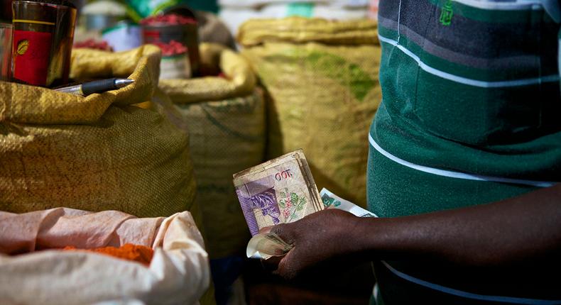 A trader attends to a customer (Photo: Abraham Ali)