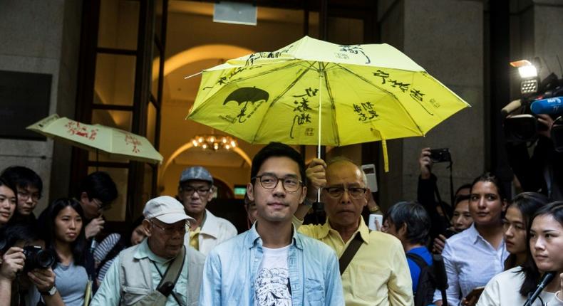 Pro-democracy activist Nathan Law (C) says he has relocated to Britain after fleeing Hong Kong because of a tough new security law imposed by Beijing