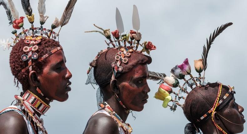 TOPSHOT - Men of the Samburu tribe perform during the 11th Marsabit Lake Turkana Culture Festival in Loiyangalani near Lake Turkana, northern Kenya, on June 28, 2018. - The annual 3-day festival featurs the cultural traditions of 14 ethnic tribes in Marsabit county to promote tourism and build better relationship between tribes. (Photo by Yasuyoshi CHIBA / AFP via Getty Images)