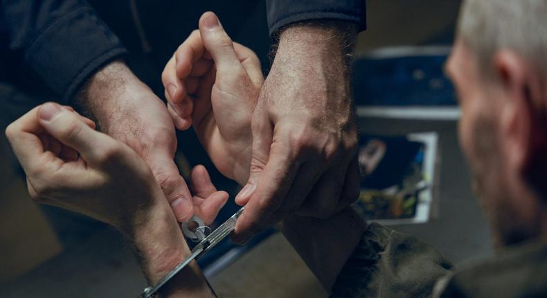 A stock image shows an officer removing handcuffs from criminal's hands.Getty Images