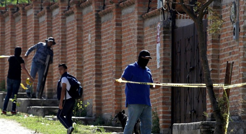 Authorities at work in  the El Mirador neighborhood of Tlajomulco de Zuniga in Jalisco, Mexico, where the remains of at least 50 people were found in a mass grave