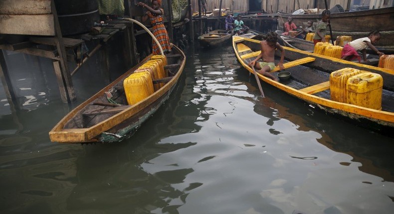 People fetch water in containers in canoes at a water selling point in the Makoko fishing community on the Lagos Lagoon, Nigeria February 29, 2016. 