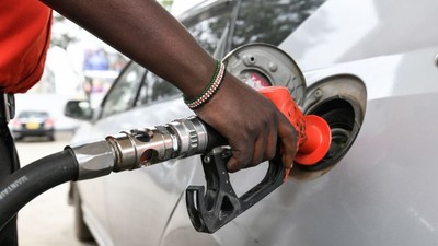 A pump attendant fills the tank of a car at a petrol station in September 4, 2018 in Nairobi as a 16 per cent VAT on petroleum products was decided and fuel distributors refused to collect stocks from depots [Photo by SIMON MAINA/AFP via Getty Images]