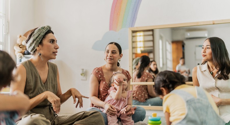 Parent's talk amongst themselves in a playroomFG Trade Latin/Getty Images