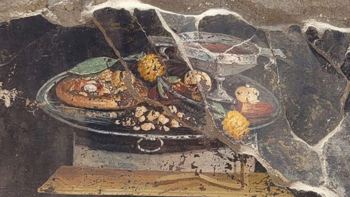Fresk znaleziony w Pompejach. Widzimy na nim potrawę przypominającą współczesną pizzę.