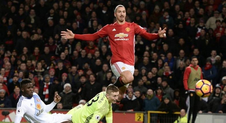 Manchester United's Zlatan Ibrahimovic lifts the ball over Sunderland's goalkeeper Jordan Pickford to score the team's second goal during the match at Old Trafford on December 26, 2016