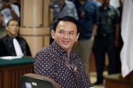 Jakarta's Governor Basuki Tjahaja Purnama smiles to the visitors inside the courtroom during his blasphemy trial at the North Jakarta District Court in Jakarta