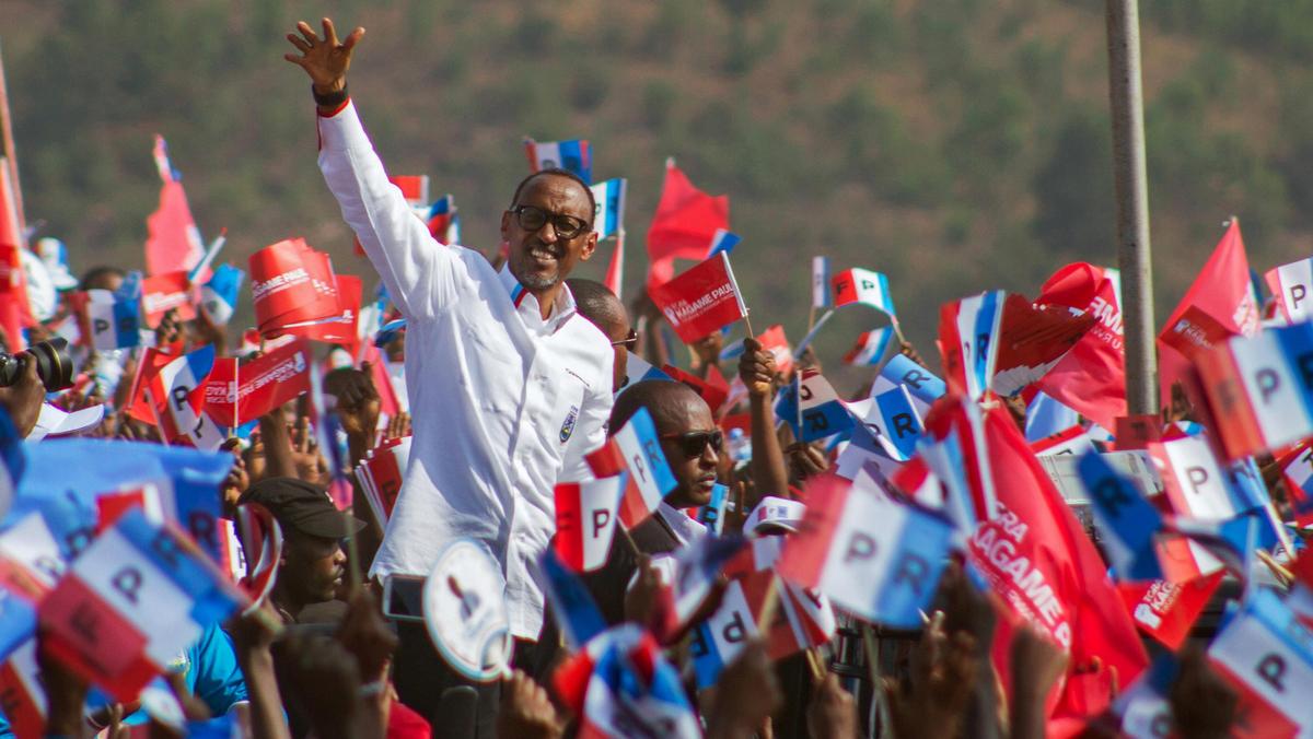 Rwandan President Paul Kagame of the ruling Rwandan Patriotic Front waves to his supporters during h