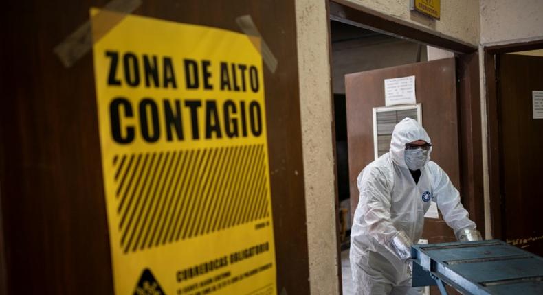 An employee wears protective gear while working at the Azcapotzalco crematorium  in Mexico City, on August 6, 2020, amid the COVID-19 coronavirus pandemic