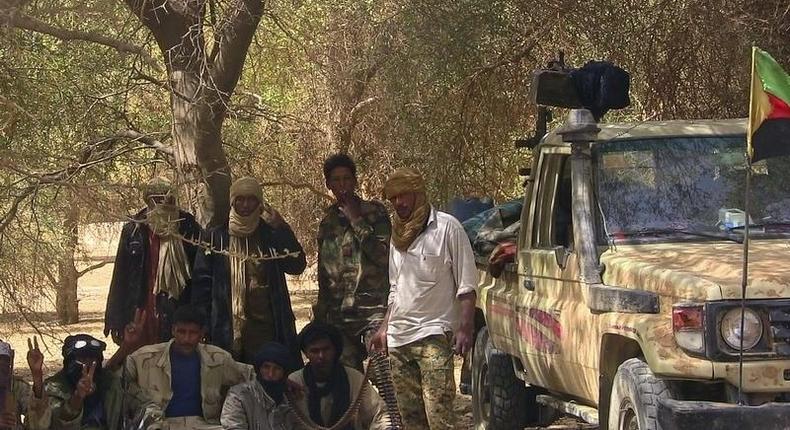 Fighters from the Tuareg separatist rebel group MNLA take shade under a tree in the desert near Tabankort, February 13, 2015.    REUTERS/Souleymane Ag Anara