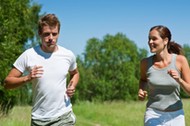 Sportive man and woman jogging outdoors